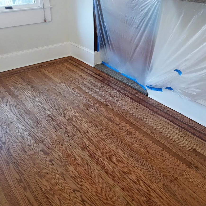 new stain applied on freshly sanded wood floor